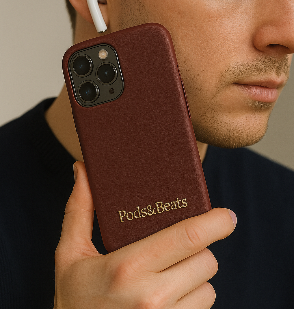 Person holding a brown phone case with 'Pods&Beats' branding
